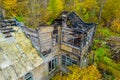 Photo of the ruins of a burnt wooden house after fire