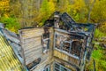 Photo of the ruins of a burnt wooden house after fire