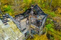 Photo of the ruins of a burnt wooden house after fire