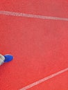 photo of a running track at a sports stadium with blue shoes at the end Royalty Free Stock Photo