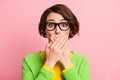 Photo of sad guilty young lady dressed yellow shirt glasses arms cover mouth pastel pink color background