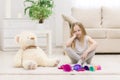 Photo of sad little girl sitting on the floor with toys. Royalty Free Stock Photo