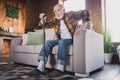 Photo of sad lonely retired man dressed plaid shirt need help nursery cane getting up couch indoors apartment Royalty Free Stock Photo