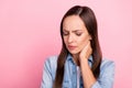 Photo of sad mature lady feel sick wear jeans shirt isolated over pink color background