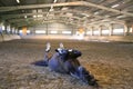 Photo of a saddle horse rolling in the dust at empty riding hall Royalty Free Stock Photo