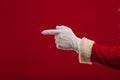 Photo of Santa Claus gloved hand in pointing gesture. fingers Royalty Free Stock Photo