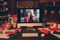 Photo of santa claus house desk computer virtual video call wave hand hello woman xmas eve indoors inside home