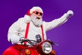 Photo of santa claus role man rapid riding newyear party by bike excited to see friends using super powers to move fast Royalty Free Stock Photo