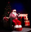 Photo of santa hold gamepad legs in basin wear x-mas costume hat glasses isolated decorated black color background