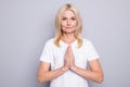 Photo of satisfied aged person hands palms together plead smile look camera isolated on grey color background