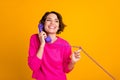 Photo of satisfied girl call telephone listen enjoy news wear jumper isolated over bright color background