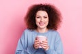 Photo satisfied girl wavy hairdo blue sweatshirt hold cup fresh aromatic coffee cappuccino drink enjoy mornings isolated