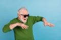 Photo of satisfied overjoyed funny granddad arms make moves dancing isolated on blue color background