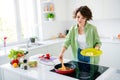 Photo of satisfied peaceful person enjoy home cookery arm hold plate spatula frying pan prepare eggs sausage mushrooms