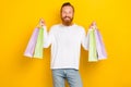 Photo satisfied positive man hand arm hold new clothes choose nice outfit enjoy isolated on yellow color background