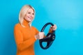 Photo of satisfied taxi driver woman hold her new volkswagen polo steering wheel copyspace road isolated on aquamarine Royalty Free Stock Photo