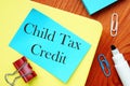 The photo says Child Tax Credit. Notepad, marker