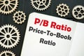 The photo says Price-To-Book Ratio P/B Ratio. Notepad, marker