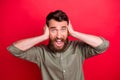 Photo of scared horrified frightened afraid man screaming in fear while with red background