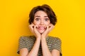 Photo of scared horrified lady wear striped t-shirt biting fingers isolated yellow color background