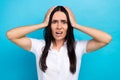 Photo of scared impressed girl dressed white shirt arms head open mouth isolated blue color background