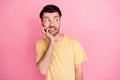 Photo of scared impressed guy with brunet hairstyle yellow t-shirt biting fingers look empty space isolated on pink