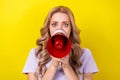 Photo of scared impressed woman dressed violet t-shirt screaming loud speaker isolated yellow color background