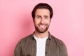 Photo of scared impressed young guy dressed brown shirt big eyes showing teeth isolated pink color background