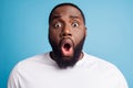 Photo of scared nervous troubled young man open mouth wear white t-shirt over blue background