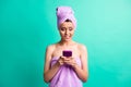 Photo of scared troubled lady bite lips morning shower hold telephone wear violet towels isolated teal color background