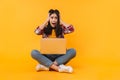 Photo of scared woman expressing shock while sitting on floor Royalty Free Stock Photo