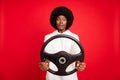 Photo of scary curly hairdo young lady drive car wear white sportswear isolated on red color background Royalty Free Stock Photo