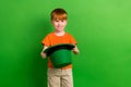 Photo of schoolboy prepare family saint patrick celebration wear leprechaun hat isolated on green color background Royalty Free Stock Photo