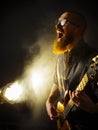 Screaming bass player in front of spotlight Royalty Free Stock Photo