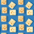 Photo seamless pattern of yellow-brown biscuits with shadows on a colored blue background.