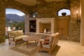 Seating furniture with fireplace in patio of mansion