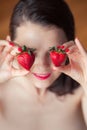 Photo of seductive female holding strawberry near face eyeys, cl