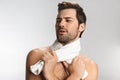 Photo of seductive half-naked man posing with towel and looking aside Royalty Free Stock Photo