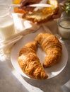 In the photo we see a morning breakfast - croissants with an appetizing golden brown crust. Close-up. Macro photography. In the Royalty Free Stock Photo