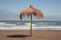 beach in the pacific ocean on  sunny day and  rustic  umbrella in the middle of Royalty Free Stock Photo