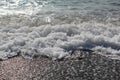 Waves with foam break on the beach shore on the Black Sea Royalty Free Stock Photo