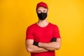 Photo of self-assured man crossed hands cool look wear mask red t-shirt hat isolated yellow color background