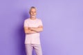 Photo of self-assured old man calm face folded hands wear pink pants t-shirt isolated purple color background Royalty Free Stock Photo