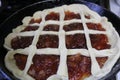 Semi-finished Apple pie on a frying pan Royalty Free Stock Photo