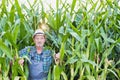 Senior farmer standing in corn plants growing in field Royalty Free Stock Photo