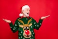 Photo of senior man holding sale products on open palms advising low holiday prices wear x-mas ugly ornament sweater and