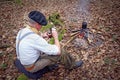 Senior active man camping in woods with yerba drink Royalty Free Stock Photo