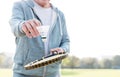 Midsection of senior man with shuttlecock and tennis racket in park Royalty Free Stock Photo