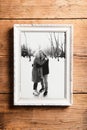 Photo of seniors in picture frame laid on wooden background. Royalty Free Stock Photo