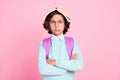 Photo of serious boy hold book cover head crossed hands wear bag teal shirt isolated pink color background Royalty Free Stock Photo